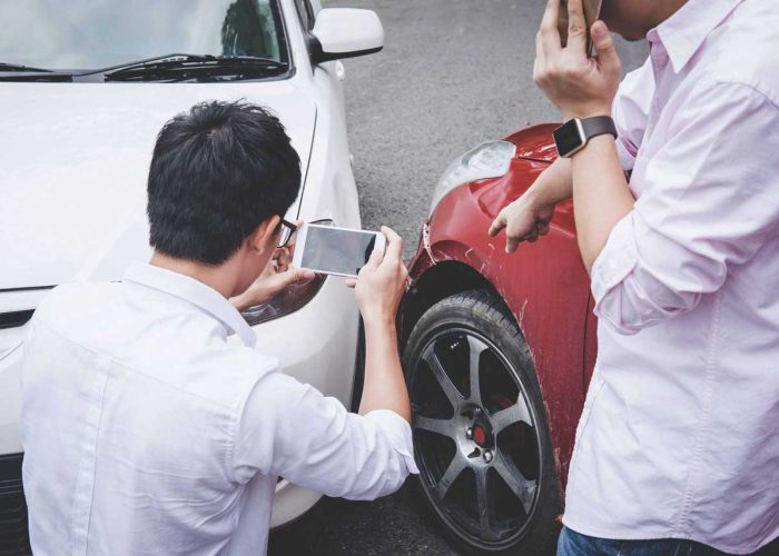 Two drivers man arguing after a car traffic accident collision and making phone call to Insurance Agent and take a photo, Traffic Accident and insurance concept